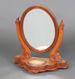 A Victorian oval plate dressing table mirror contained in a mahogany swing frame, the shaped base of serpentine outline fitted a ring box 63cm h x 55cm w x 25cm d 