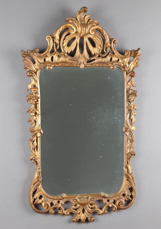 A 1950's rectangular plate mirror contained in a pierced gilt composition frame 86cm x 48cm 