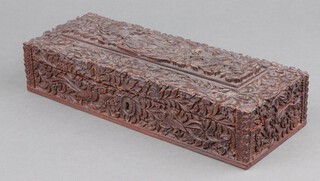 A Victorian Indian deeply carved hardwood rectangular glove box, the lid decorated a figure of a huntsman, 2 lions and other beasts 6cm x 29cm x 11cm  