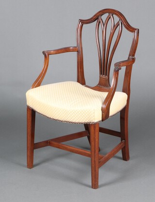 A 19th Century mahogany Hepplewhite style shield back carver chair with fan shaped shield back and over stuffed seat upholstered in yellow material, raised on square tapered supports 91cm h x 51cm w x 43cm d  