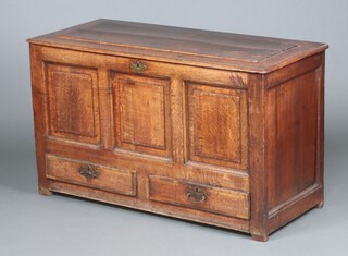 An 18th Century oak mule chest of panelled construction with hinged lid and iron lock, the interior fitted a candle box, the base fitted 2 crossbanded drawers with iron locks 76cm h x 127cm w x 55cm d  