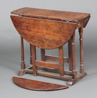 An 18th Century oak drop flap gateleg table fitted a frieze drawer, raised on turned supports 67cm h x 81cm x 27cm 