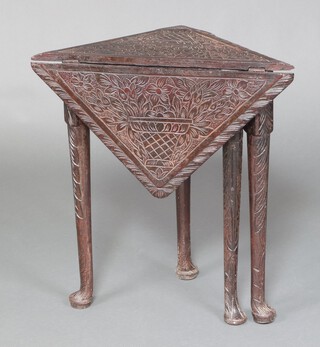 A Victorian carved oak corner table decorated a basket of flowers, raised on club supports 69cm h x 65cm w x 45cm d 