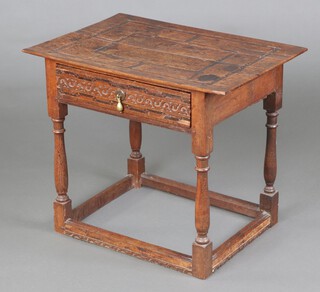 A 17th Century carved oak side table with indented top, fitted a drawer with blind fret work carving, raised on turned and block supports 56cm h x 65cm w x 46cm d 