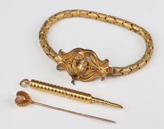 A Victorian gilt bracelet set with a citrine, a propelling pencil and a citrine tie pin 