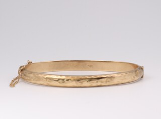 A 9ct yellow gold engraved bangle, together with a 9ct yellow gold locket 9.1  grams 