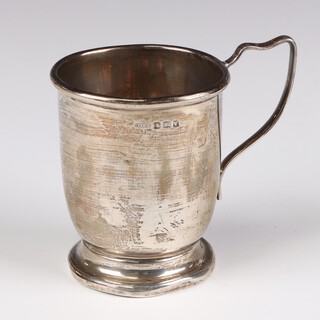 A silver mug with engraved monogram and scroll handle, Birmingham 1945, 8cm, 100 grams