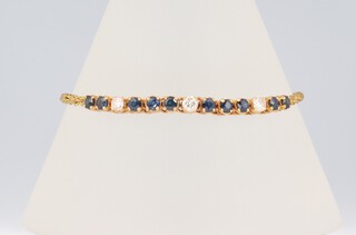 An 18ct yellow gold diamond and sapphire bracelet with rope twist chain, the diamonds 0.30ct, the sapphires 1.0ct, 18cm 