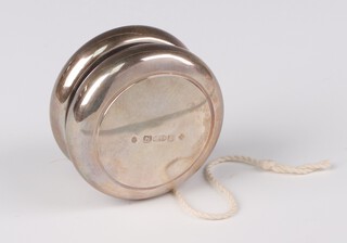 An Asprey & Co. silver yoyo London 2000, 5.5cm, gross weight 84 grams, boxed