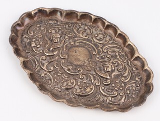 A Victorian scallop shape silver pin tray decorated with cherubs and scrolls Birmingham 1897, 12cm, 38 grams 