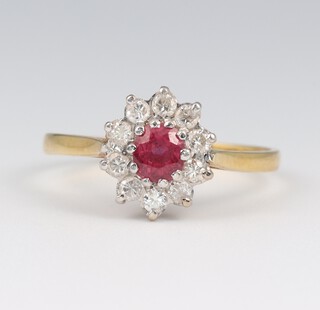 An 18ct yellow gold ruby and diamond cluster ring, the centre stone 0.4ct, the diamonds 0.3ct. size S, 3 grams