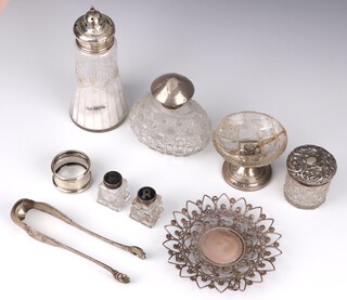 A pair of Continental silver sugar nips with claw bowls, a silver mounted oval scent, toilet jar, salt and pepper, napkin ring, a mounted sugar shaker, mounted glass tazza and pierced dish, weighable silver 204 grams 