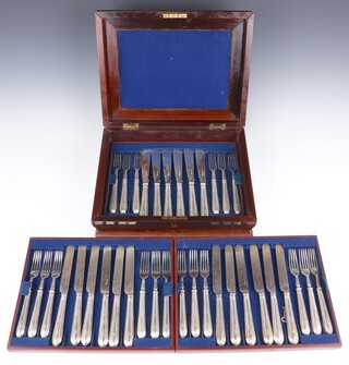 A canteen of silver plated cutlery with beaded  handles and crest comprising 12 desert knives and forks, 12 fish knives and forks, contained in a mahogany box 