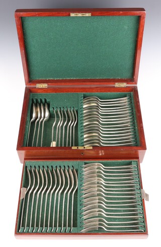 A set of Old English pattern silver cutlery comprising 12 dinner forks, 24 dessert forks, 18 dessert spoons, 4 table spoons, with crest all London 1915, maker Brewis and Co., total weight 3410 grams, contained in a mahogany canteen 