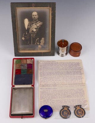 Of Royal Interest, The Duke of Gloucester, a large silver engine turned cigarette case with cypher The Duke of Gloucester, Birmingham 1929, maker Henry Hodson Plante, in original fitted case together with a ladies silver and guilloche enamel circular compact with coronet mount (bruised) 5cm, together with a leather bound photograph of The Duke of Gloucester signed and dated December 1930, a plated travelling cup and 2 cloth badges with an associated letter detailing his Royal Highnesses visit to the recipients of the above 