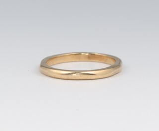 A 9ct yellow gold wedding band (misshapen) size J, 2 grams 