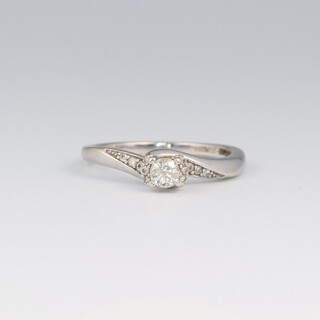 A 9ct white gold cross over diamond ring, approx. 0.25ct, size N, 2.5 grams 