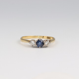 An 18ct yellow gold 3 stone diamond and sapphire ring, the centre stone 0.25ct, the 2 diamonds 0.08ct, 2 grams, size M 1/2