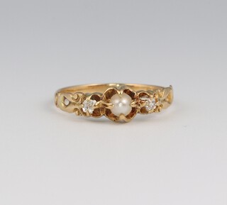 An 18ct yellow gold diamond and seed pearl ring, the diamonds 0.02ct, the pearl 3mm, size N, 2.2 grams 