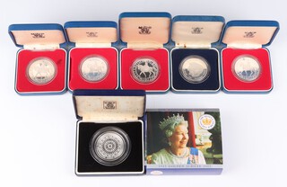 Four 1977 silver commemorative crowns, a 1981 wedding ditto, a 1986 Royal Wedding ditto and a 2002 Golden Jubilee ditto, cased, 205 grams 