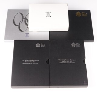 A Millennium cased coin set, a 2005 United Kingdom proof set, a 2010 proof coin set, 2 2013 proof coin sets