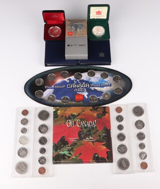 Three Canadian silver commemorative dollars 1981, 1985, 2002, 75 grams, 2 Royal Canadian Mint 1989 proof coin sets, 4 coin sets 1968, 1969, 1972, 1973, a 2000 Millennium coin set, a 1994 uncirculated coin set and a bronze plated proof dollar 1995