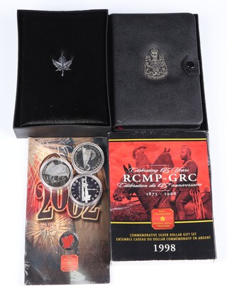 Four Canadian silver commemorative dollars 1984, 1986, 1995 and 1998, 80 grams, 2 commemorative Canadian Royal Mint coin sets 1975, 1986 and a commemorative coin 