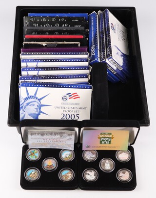 A quantity of United States proof coin sets 1969, 1973, 1976-78, 1979 (x2), 1980, 1992, 1999, 2000, 2002 (x2), 2005 (x2), 2006, 2 mint quarters collections 2000 and 2001, 2 gilt cased National Parks coins