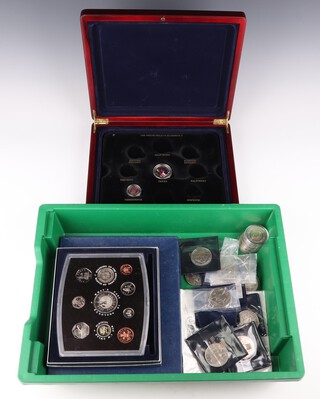 Four albums of commemorative cupro nickel coins and covers, an album of covers and minor coins 