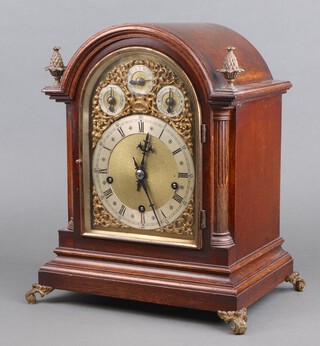 Winterhalder and Hofmeier, an Edwardian 8 day striking on 9 gongs bracket clock, the 17cm arched gilt dial with silvered chapter ring, Roman numerals, chime/silent dial, slow/fast dial and chiming on 8 gongs/chiming on 4 gongs dial, complete with pendulum and key, contained in an arched oak gilt mounted case 36cm h x 31cm w x 23cm d 