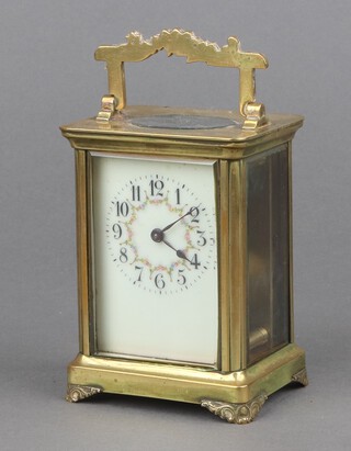 A 19th Century French 8 day carriage timepiece with 5.5cm enamelled dial, Arabic numerals and floral garlands, contained in a gilt metal case 11cm x 8cm x 6cm 