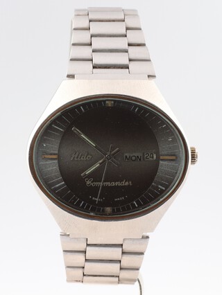 A gentleman's mid-century Mido steel cased automatic wristwatch with day/date aperture, Mido Commander, in an elliptical case 40mm with original steel bracelet 