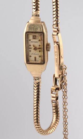 A lady's 9ct yellow gold Rotary wristwatch contained in a rectangular case on a 9ct bracelet, 9.8 grams including the glass 

