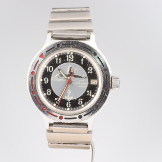 A mid-century steel cased Russian wristwatch with 2 colour bezel and calendar aperture, the dial inscribed Komandirskie Vostok with screw down winder 35mm, on a steel bracelet 