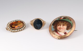 A gentleman's 9ct yellow gold onyx set signet ring size R, 4.3 grams, a 9ct yellow gold mounted porcelain portrait brooch (cracked) and a gilt citrine and seed pearl brooch