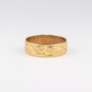 A 22ct yellow gold engraved wedding band size L, 4.4 grams 