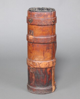 A cylindrical leather twin handled military cordite carrier marked J.A.H. with broad arrow and N 73cm h x 23cm diam., complete with metal liner 