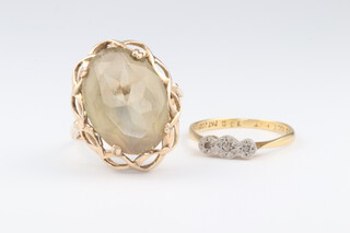 A 9ct yellow gold smoky quartz ring, size Q, 4.7 grams and an 18ct yellow gold 3 stone diamond ring 0.01ct, size K 1/2, 1.3 grams