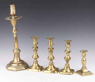 A pair of 18th Century brass candlesticks with ejectors 21cm, a similar 20cm (hole to stem), a large brass candlestick with octagonal base converted to a table lamp 43cm, an 18th Century brass candlestick with diamond shaped base 15cm 
