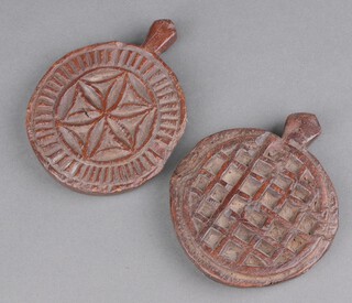 A pair of 18th Century circular carved wooden butter stamps 10cm 