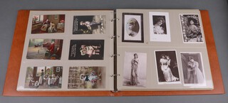 An album of 324 black and white and coloured postcards, some humorous 