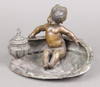 After Kossowski, a bronzed inkwell with hinged lid in the form of a cherub seated within an oyster shell 12cm h x 21cm w x 12cm d 