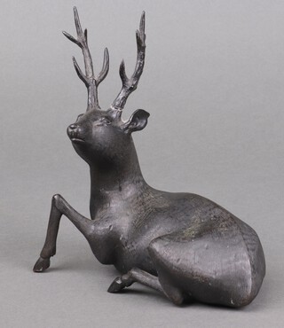 A Meiji Period Japanese bronze figure of a reclining deer with character mark to base 16cm 