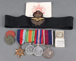 A group of 4 medals to Acting Pilot Officer 48612 R. C. Kemp Royal Air Force, comprising 1939-45 Star, Defence and War medal and George VI issue RAF Long Service Good Conduct medal, together with 2 dog tags, medal certificate, officer's cap badge and the Kings badge, boxed