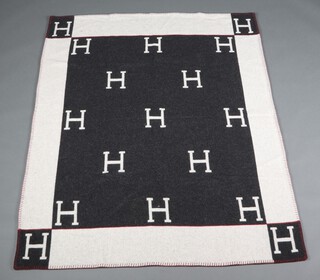 Hermes, a grey and black wool and cashmere blanket with the distinctive H logo, labelled Hermes, 171cm x 135cm 