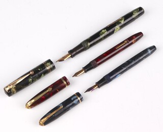 A Swan green marbled fountain pen with 14ct nib, a Conway Stuart pink marbled Dinky 550 fountain pen with 14ct nib and a blue marbled ditto with 14ct nib