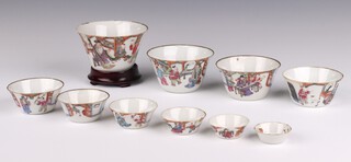 A set of ten graduated famille rose cups, Late Qing dynasty, Daoguang period   each painted with a scholar and attendant, within an interior, the largest with a Daoguang seal mark and of the period, the largest - 10cm diameter (10)
