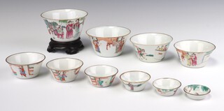 A set of ten graduated famille rose cups, Late Qing dynasty, Daoguang period each painted with a scholar, ladies and attendants, in walled gardens, the largest -  11cm diameter (10)
