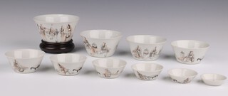 A set of ten graduated iron-red and sepia cups, Late Qing dynasty,  each painted with scholars conversing, the largest - 10.5cm diameter (10)


