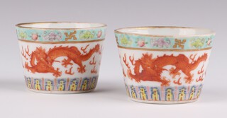 A pair of famille rose dragon cups,  Guangxu marks and period, each painted with a central band of two five-claw dragons, 4cm h x 5.5cm diameter (2)